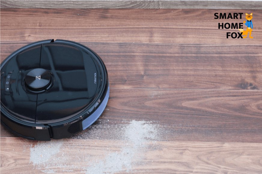 Roborock S6 MaxV vacuums sand on a hard floor.